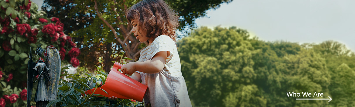 Image of little girl with flowers links to Who We Are page